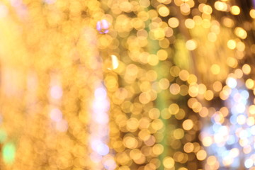 Bokeh background gold yellow colorful of merry christmas, Happy new year bokeh lighting shine on night background, Bokeh glitter light, Gold Luxury backdrop texture, Glittering wallpaper