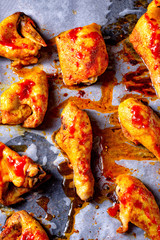 Rustic backed chicken wings,legs on baking tray