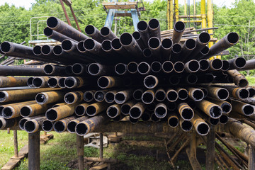 Oil Drill pipe. Rusty drill pipes were drilled in the well section. Downhole drilling rig. Laying...