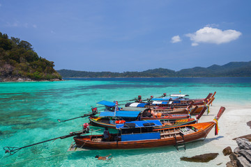 White sand beach beach and long tail boat is floating on sea at ocean in Tropicana located at south of thailand 