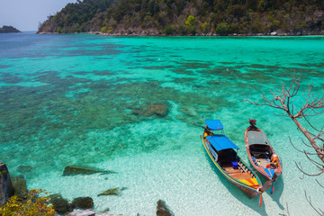 White sand beach beach and long tail boat is floating on sea at ocean in Tropicana located at south...