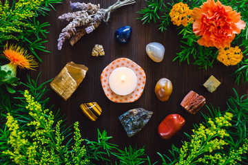 Lit Candle with Stones and Flowers of Summer