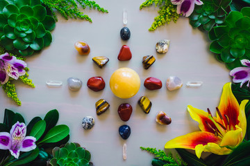 Crystal Grid on Grey Table with Summer Botanicals