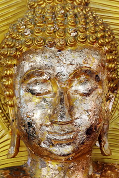 golden buddha face statue close-up, buddha statue