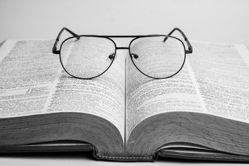 Glasses on open book with black and white style