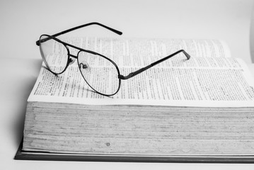 Glasses on open book with black and white style