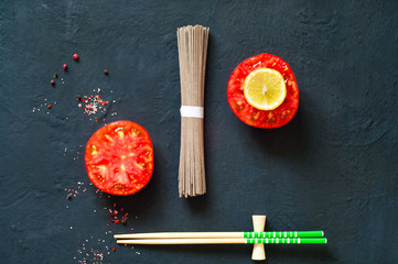traditional  japanese soba noodles and ingredients on dark background, concept of   asian food and healthy diet,  copy space, closeup 
