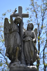 Weathered sculpture of a warning angel on a tomb of the cemetery of Montreal-Canada