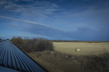 View from train at hay bales