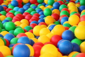 Fototapeta na wymiar Children's party, toys – a lot of colorful plastic balls in a dry pool: red, green, blue, yellow.