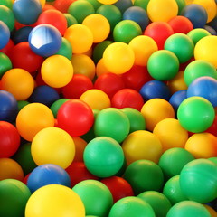 Fototapeta na wymiar Children's party, toys – a lot of colorful plastic balls in a dry pool: red, green, blue, yellow.
