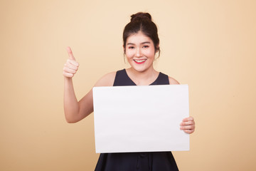 Young Asian woman show thumbs up with  white blank sign.