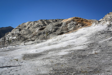Water pours over a deposited limestone terrace at Mammoth Hot Springs in Yellowstone National Park, Wyoming.