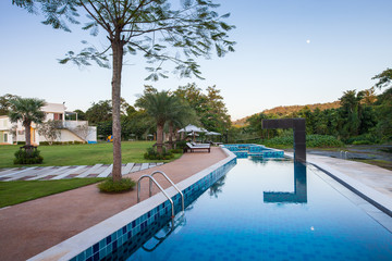 Swimming pool out door with green grass field