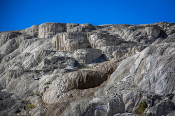 Water pours over a deposited limestone terrace at Mammoth Hot Springs in Yellowstone National Park, Wyoming.