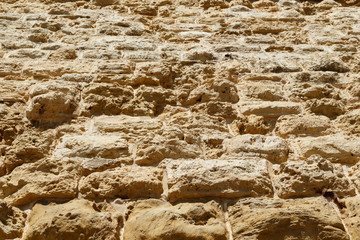 weathered Limestone texture background, blocks make the huge stone walls of the castle of Fort