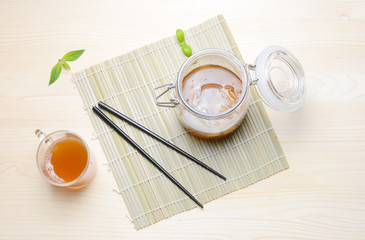 Fresh home made Kombucha fermented tea on a wooden background.