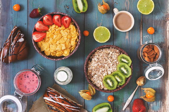 Breakfast with cereals, fruits and berries on a blue rustic background. View from above, flat lay.Toned photo