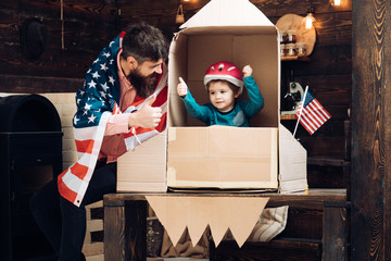 Dream about career of cosmonaut. Father and small boy in paper rocket with American flag. Happy independence day of the usa. Family and childhood. Patriotism and freedom. Travel and adventure