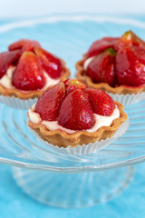 Tartlets with strawberries and cream. Dessert with fresh fruits.