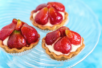 Tartlets with strawberries and cream. Dessert with fresh fruits.