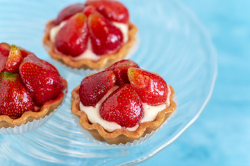 Tartlets with strawberries and cream. Dessert with fresh fruits.