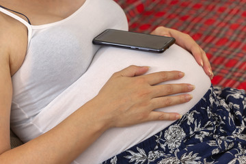 Pregnant woman using cell phone