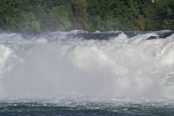 View of a powerful waterfall on the River Rhine in Switzerland, the beauty of Europe.