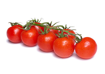 Fresh cherry tomatoes with water drops isolated on white background.