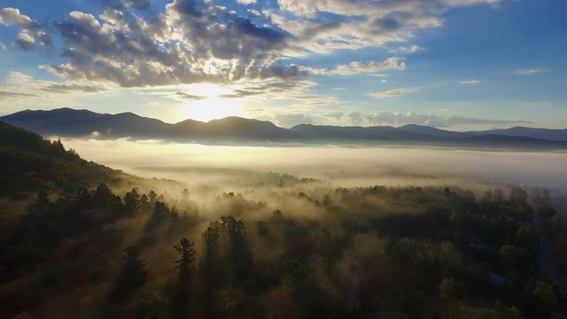 Sunrise aerial of the Adirondack mountains with dramatic low dense fog