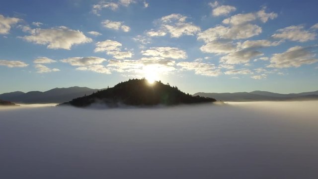 Aerial of an Adirondack peak surrounded by a morning fog