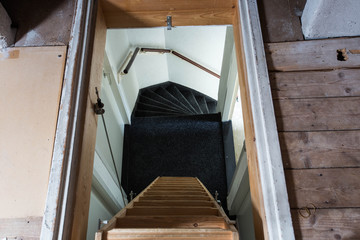 A wooden ladder in the attic in a rustic interior