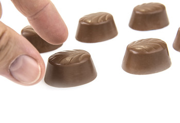 Delicious chocolate pralines on the white. Sweet candy