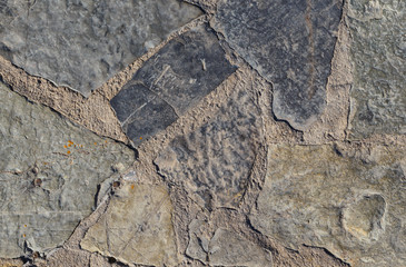 Gray texture of rough stone on the road