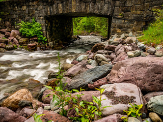 The stone bridge that allows passage over Snyder Creek in Glacier National Park