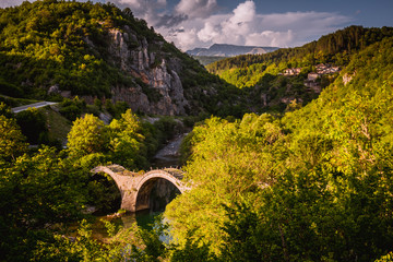 Plakidas Bridge with Kipi village on background.
Arches stone bridge of Kalogeriko on the river of...
