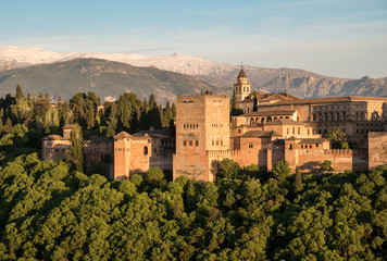 View of Charles V palace and Palacios Nazaríes of Alhambra in Granada with Sierra Nevada mountains, Andalusia, Spain