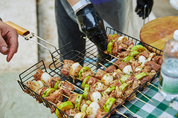 spread skewers of meat and vegetables on the grill