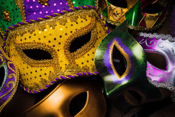 multiple Mardi Gras masks on a dark background
