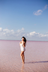Fototapeta na wymiar Beautiful girl on a pink lake.