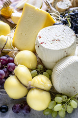 Soft and hard cheeses with grapes
