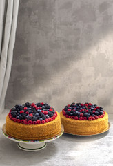 Two honey cakes with blueberries and raspberries