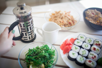 healthy kale and avocado sushi roll with chopsticks