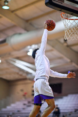 Athletic High School Basketball Player Making a Slam Dunk