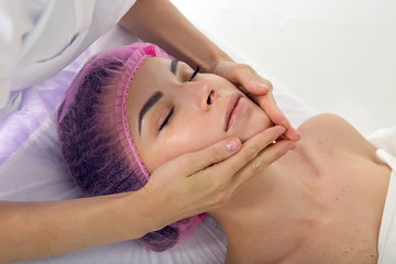 Obraz na płótnie Canvas massage therapist cosmetologist doing massage of the shoulders, the girl lying