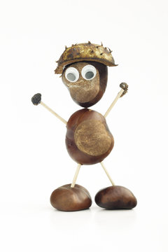 Funny human shape character or figurine made with chestnuts in white isolated background