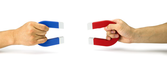 Two people pull holding magnets