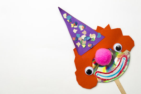 Creative clown shape made with cd and paperboard in isolated white background