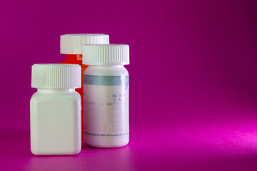 Three Pill Bottles on Pink