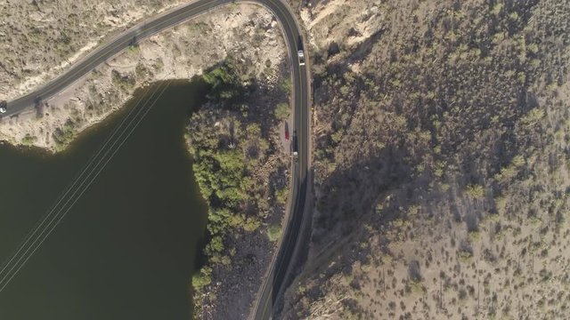 4K Aerial of Truck Driving Near Desert Mountain Lake.
